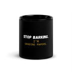 Black ceramic mug with Stop Barking I'm Grading Papers text in white letters