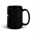 Teacher holding black Stop Barking I'm Grading Papers coffee mug at desk