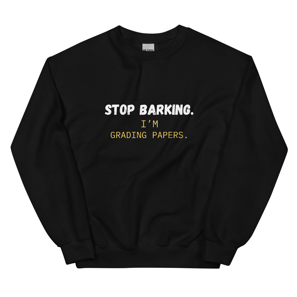 Close-up of white Stop Barking I'm Grading Papers text on navy sweatshirt chest